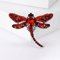 Detail of dragonfly brooch with vibrant red crystals and silver metal setting - Red