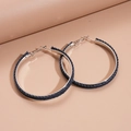 Detail van grote ronde oorringen met donkerblauwe denim stof op zilveren metalen frame - Blauw