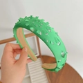 Green satin headband with hollow leaf patterns and elegant beige lining details - Green