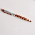 Detail of rose gold crystal ballpoint pen filled with light blue and clear gravel stones - Aquamarine