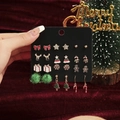 Set of 12 Christmas earrings featuring reindeer, trees, and candy canes on black card - 12 Pairs/Set Christmas Bowknot Star Gift Box
