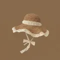 Khaki straw sun hat featuring delicate white lace trim and a bow tie strap detail - Lace Edge Khaki