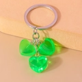 Detail of green jelly resin hearts on a silver keychain against an orange background - Green