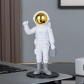 White astronaut figurine with gold mask holding a briefcase on a round black base - No.12 Gold Model A