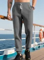 Dettaglio dei pantaloni sportivi grigi da uomo con trama jacquard e coulisse in vita - Taglia S / Pantaloni e gonne / Grigio scuro