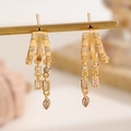 Macro view of gold fringe earrings featuring sparkling cubic zirconia and tassels - Gorgeous Long Tassel Earrings (5889) / KC Gold