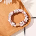 Detail of floral printed scrunchie with pink flowers on a rustic wooden tray - Satin Floral White