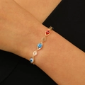 Close-up of golden chain bracelet featuring colorful evil eye beads on female wrist - Evil Eye Bracelet (G-468) / KC Gold