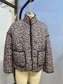 Detailed view of women's short quilted jacket with pink floral pattern and black piping - Orange and Black Small Print