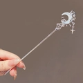 Elegant silver moonstone hair pin with star tassel design worn by model on grey background - Dreamy Liquid Moon - Silver