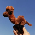 Realistic brown camel plush keychain pendant held against a clear blue sky. - Camel-Dark Brown / 12cm
