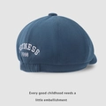 Detail view of children's navy beret featuring OUTNESS 1998 embroidery and elastic strap - Kids One Size / Blue