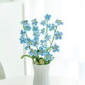 Handmade crochet blue forget-me-not flowers in white ceramic vase on table - 7-Head Forget-Me-Not Blue