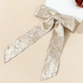 Detail of champagne gold velvet bow hair clip with elegant long ribbon texture - Long Ribbon Bow / Apricot