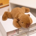 Adorable brown capybara plush toy in a lying position with soft high-quality fur texture - Capybara