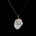Detail of wire-wrapped natural clear quartz crystal pendant on black woven cord - White Crystal