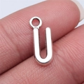 Silver alloy letter U pendant charm for DIY jewelry being held on a fingertip - Letter U (B15674) / Antique Silver