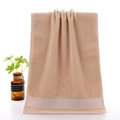 Plush light brown cotton towel with white horizontal stripes and soft loop texture - Comfy Stripe Brown