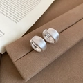 Close-up of matte brushed silver hoop earrings on a vintage brown jewelry stand - Silver Brushed Hoop Earrings (6# Hoop-Silver)