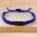 Detail of blue braided rope bracelet with black metal plate on a stone background - Royal Blue (Black Plate)