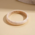 Detail view of a cream resin geometric round bangle with marble texture and brown veins - Beige-Round