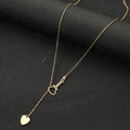 Collana in acciaio al titanio dorato con ciondolo a violino e cuore su sfondo nero opaco - Oro