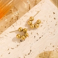 Minimalist gold ball C-shaped stud earrings on a textured stone display surface - C-Shape Five-Ball Studs / Gold