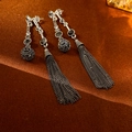 Detailed shot of vintage silver earrings with dark metal spheres and long chain tassels - Silver Needle Ball Tassel Earrings / Silver