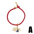Red braided cord bracelet with gold camera, globe, and airplane charms on white background - Camera Globe Style (5421958268856)