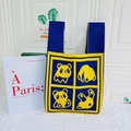Knitted tote bag with navy blue and yellow contrast featuring pixel bear patterns - Blue And Yellow Square Panda Emoji