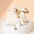 Elegant beige leather wedding favor bag with silk scarf detail and gold chain pattern - Off-white