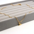 Detail of a gold-plated letter Y pendant necklace on a premium grey velvet display tray - Letter Y / Gold