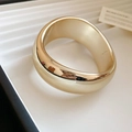 Vista detallada del brazalete ancho dorado con acabado pulido liso y diseño abierto - Estilo Irregular / Dorado