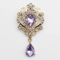 Vintage golden brooch featuring large purple teardrop crystal and sparkling rhinestones - Light Purple