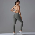 Detail of dark grey seamless yoga set showing cross back sports bra and high waist leggings - S / Dark Gray