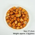 Karamellisiertes Popcorn-Modell mit 2x1,5 cm Größe und 3,5 g Gewicht in Schale - Eine Kugelförmige Popcorn-kugel – Dunkelkaramellfarben