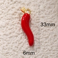 Detailed view of red chili pepper pendant with dimensions 33mm by 6mm and gold bail - Red