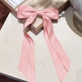 Pink satin double layer bow hair clip with flowing ribbons on a beige velvet tray - Pink