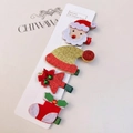 Detail of 4-piece Christmas hair clip set with Santa, hat, tree, and sock on display card - 4-Piece Felt Christmas Hair Clip Collection