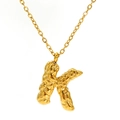 Golden necklace featuring a textured letter K pendant with unique lava ripple finish - Gold Letter-K