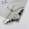 Detail of gold watch bracelet with black heart gems and marble pattern dial - Gold Black