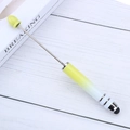 Telescopic touch screen pen with yellow gradient grip and stylus tip on wood background - Gradient Yellow