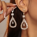 Elegant gold drop earrings with sparkling rhinestones worn by a model in a side view - Gold Pear-Shaped Pave Long Drop Earrings DTE1416009GL-W