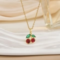 Elegant gold cherry pendant necklace with red crystals and green leaves on silk background - Cherry Pendant Style (XL0589)