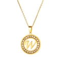 Detail of a gold circular pendant with crystal inlay and a hollow letter W design - Letter W