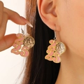 Close-up of pink 2025 disco ball earrings with gold glitter for New Year party - 2025 Numeric Disco Ball Style (6707) / White Gold