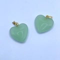 Green heart-shaped glass pendant with golden buckle and white dot pattern on a light background - Emerald Green