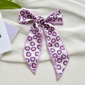 Silk feel hair scarf with purple heart print tied in a bow on a white textured background - Pink Purple Heart