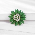 Macro view of green enamel daisy brooch with gold hollow center and white zircons - Green Rhinestone Daisy