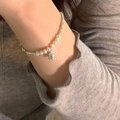 Close-up of pearl and silver bead bracelet featuring a tulip charm on a model wrist - Tulip Artificial Pearl Style (SL0929)